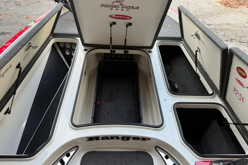 Slide: The Image of 2014 Ranger Z520 Comanche boat storage compartments open, showcasing ample space and organization. - 11