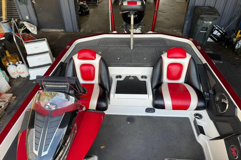 Slide: The Image of 2014 Ranger Z520 Comanche boat interior with red and black seats, Humminbird electronics. - 13