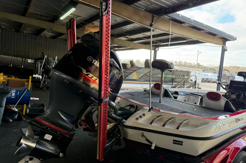 Slide: The Image of 2014 Ranger Z520 Comanche boat with Yamaha outboard motor in a covered storage area. - 3