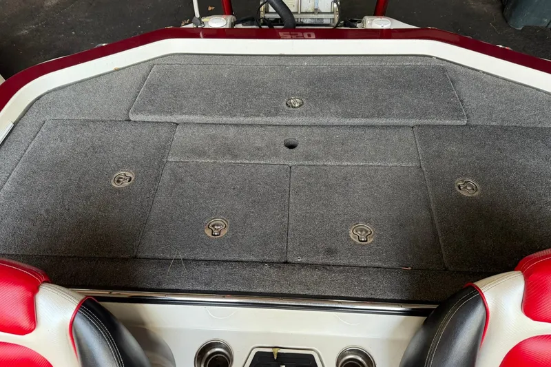 Slide: The Image of 2014 Ranger Z520 Comanche boat deck with storage compartments and red accents. - 4