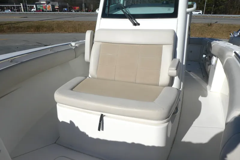 Slide: The Image of 2017 Boston Whaler 250 Outrage boat interior with cushioned seating. - 11
