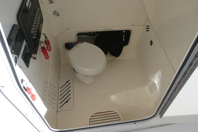Slide: The Image of Interior of 2017 Boston Whaler 250 Outrage boat with toilet and control panel. - 12