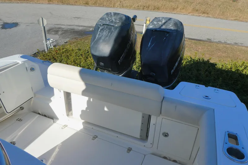 Slide: The Image of 2017 Boston Whaler 250 Outrage boat with dual outboard engines, viewed from the rear deck. - 4