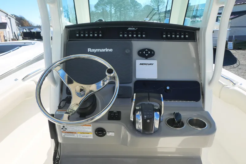 Slide: The Image of 2017 Boston Whaler 250 Outrage boat console with Raymarine electronics and Mercury controls. - 6