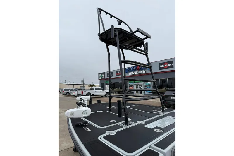 Slide: The Image of 2026 Mamba 24 Cat Elite boat with motor, parked on a wet concrete surface. - 12