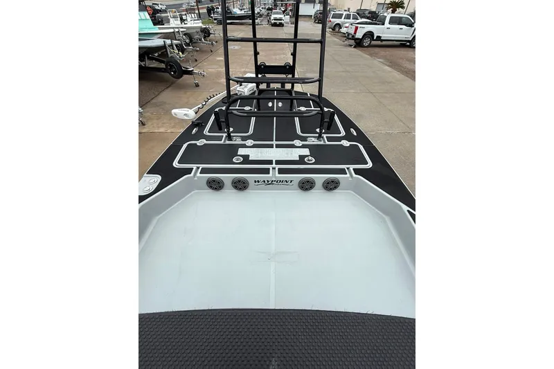 Slide: The Image of 2026 Mamba 24 Cat Elite boat interior with dual black and white seats. - 13