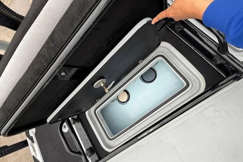 Slide: The Image of 2026 Mamba 24 Cat Elite boat with open storage compartments and livewell. - 17