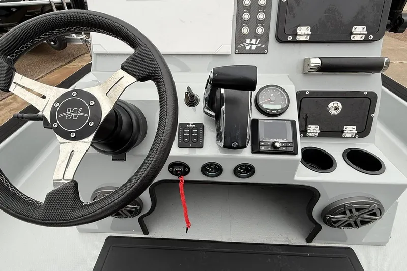 Slide: The Image of 2026 Mamba 24 Cat Elite boat, sleek design, parked outdoors. - 19