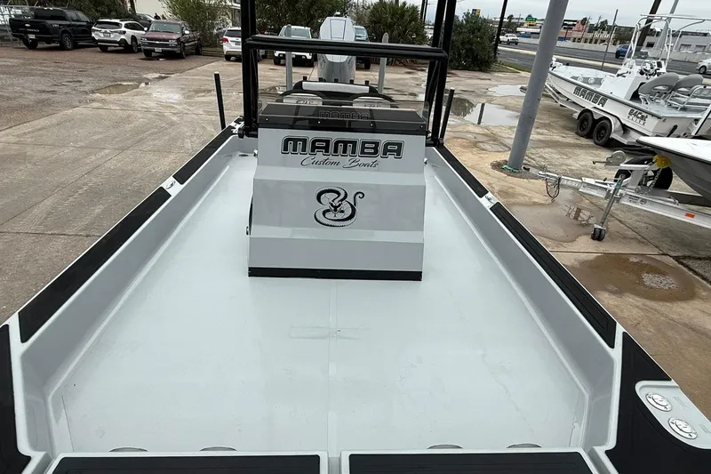 Slide: The Image of 2026 Mamba 24 Cat Elite boat, sleek design, parked at a dealership. - 20