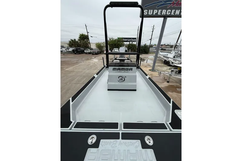 Slide: The Image of 2026 Mamba 24 Cat Elite boat, sleek design, parked on trailer, ready for adventure. - 21