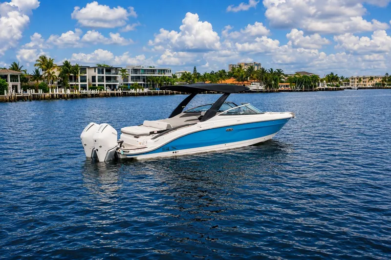 Slide: The Image of 2026 Sea Ray SLX 280 Outboard on calm water near coastal homes. - 0
