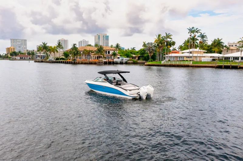 Slide: The Image of 2026 Sea Ray SLX 280 Outboard on calm water near coastal homes. - 10