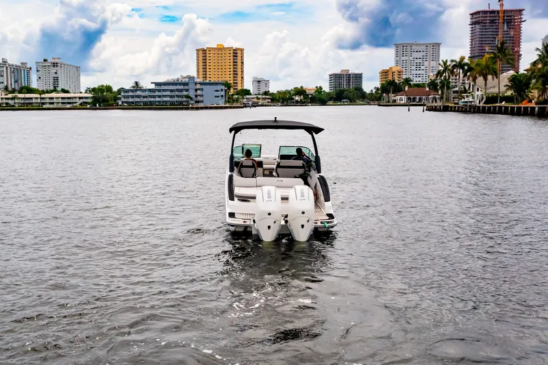 Slide: The Image of 2026 Sea Ray SLX 280 Outboard on water with city skyline. - 11