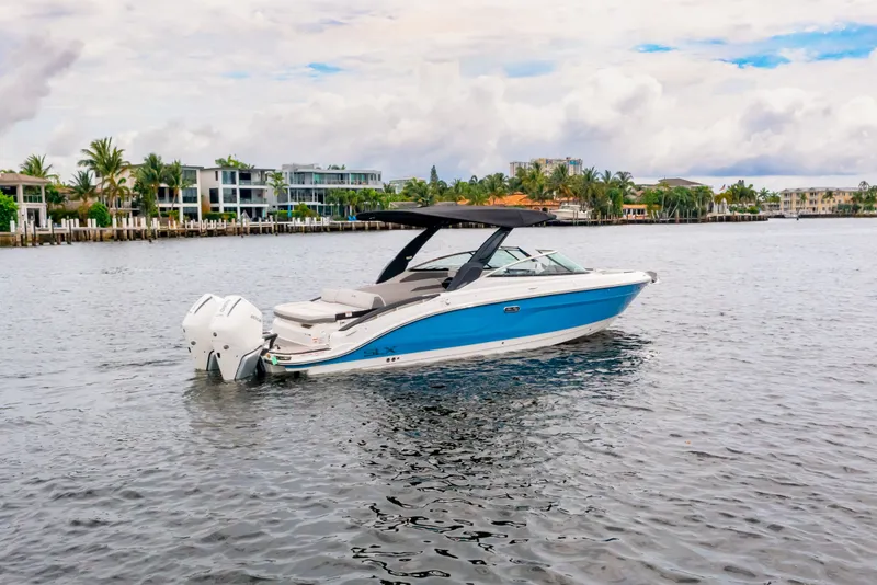 Slide: The Image of 2026 Sea Ray SLX 280 Outboard on calm water near coastal homes. - 3