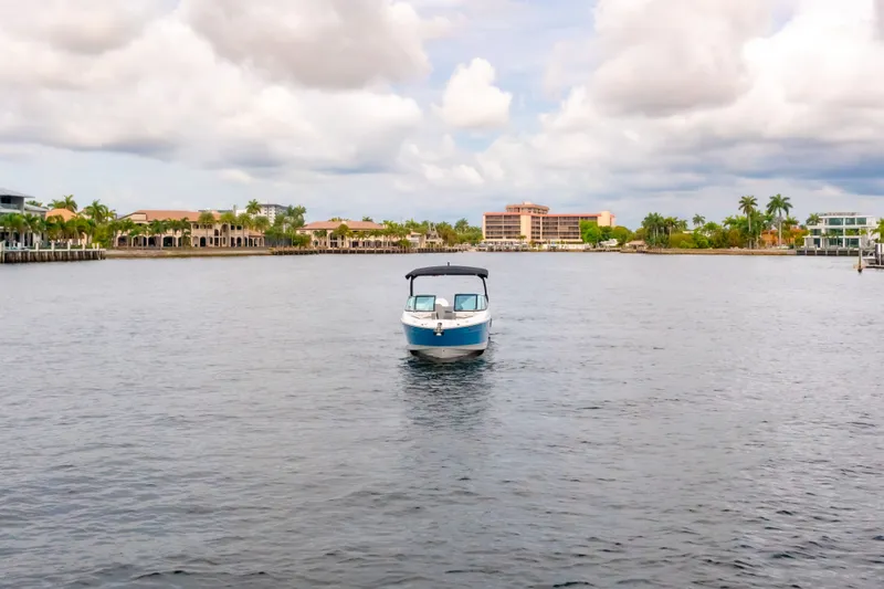 Slide: The Image of Sea Ray SLX 280 Outboard 2026 on calm water near coastline. - 5