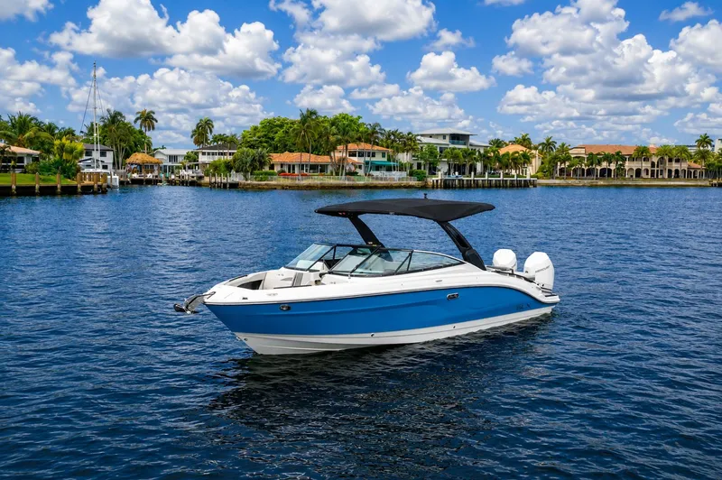 Slide: The Image of 2026 Sea Ray SLX 280 Outboard on calm water near coastal homes. - 6