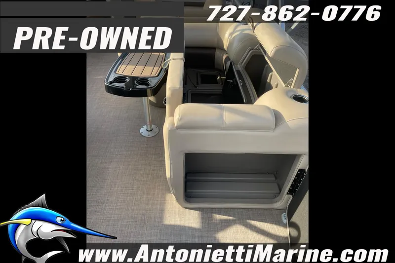 Slide: The Image of Pre-owned 2024 Sun Tracker SportFish 22 DLX boat interior with seating and table. - 11