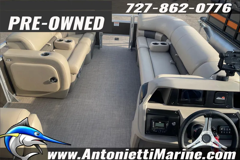 Slide: The Image of Pre-owned 2024 Sun Tracker SportFish 22 DLX pontoon boat interior with seating and controls. - 6
