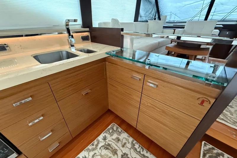 Slide: The Image of Luxurious 2016 Tiara Yachts 50 Coupe interior with modern kitchen and elegant wood cabinetry. - 16