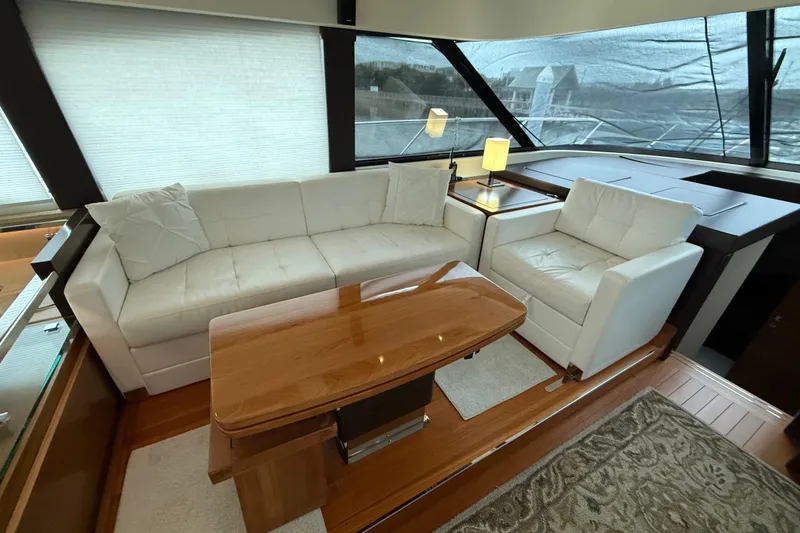 Slide: The Image of Luxurious interior of 2016 Tiara Yachts 50 Coupe with white seating and wooden table. - 23