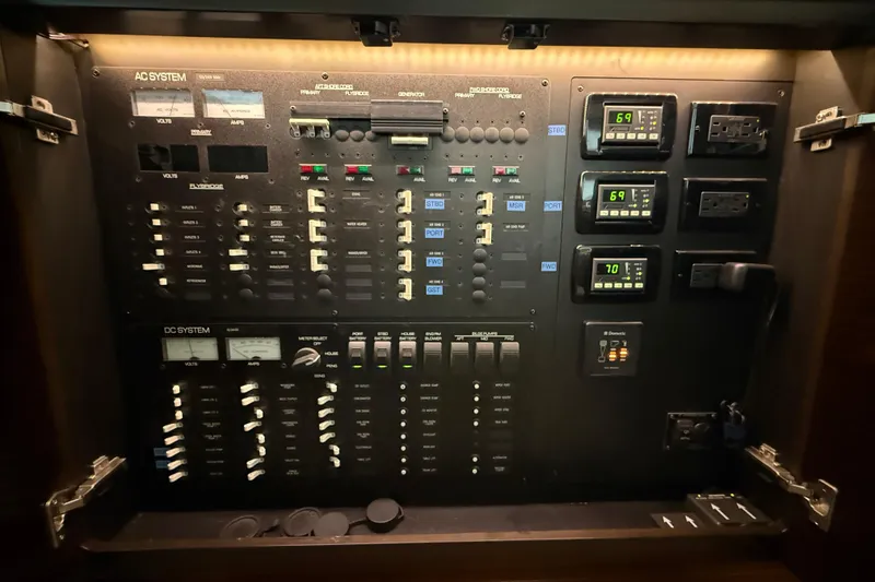 Slide: The Image of Electrical control panel of a 2016 Tiara Yachts 50 Coupe, featuring AC and DC systems. - 26