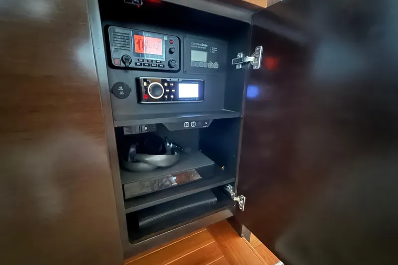 Slide: The Image of 2016 Tiara Yachts 50 Coupe electronics cabinet with navigation and audio equipment. - 27