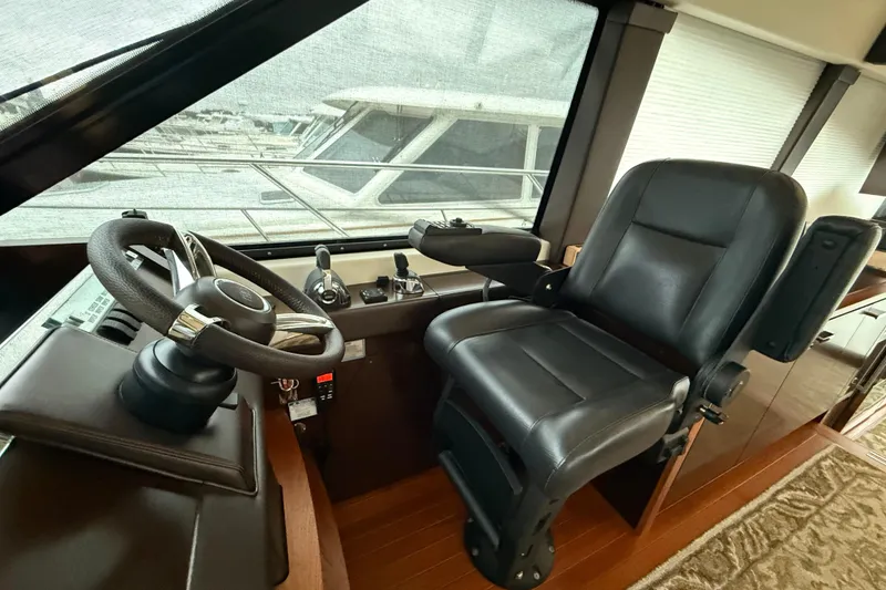 Slide: The Image of Helm station of 2016 Tiara Yachts 50 Coupe with leather captain's chair and steering wheel. - 28