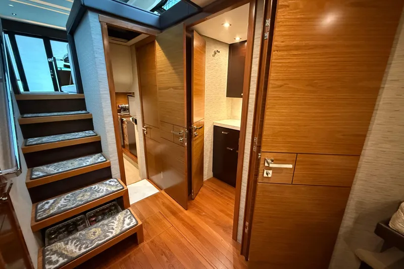 Slide: The Image of Interior of 2016 Tiara Yachts 50 Coupe, featuring wooden stairs and modern design. - 31