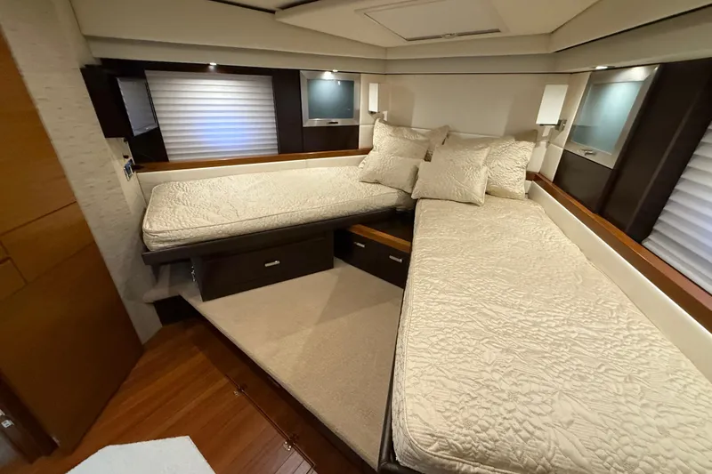 Slide: The Image of Luxurious 2016 Tiara Yachts 50 Coupe cabin with elegant twin beds and plush bedding. - 34