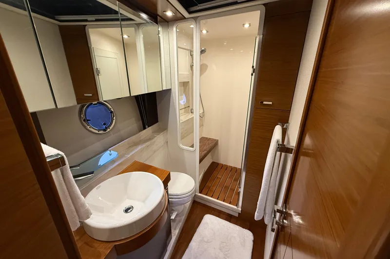 Slide: The Image of Luxurious bathroom in 2016 Tiara Yachts 50 Coupe with modern fixtures and wooden accents. - 38