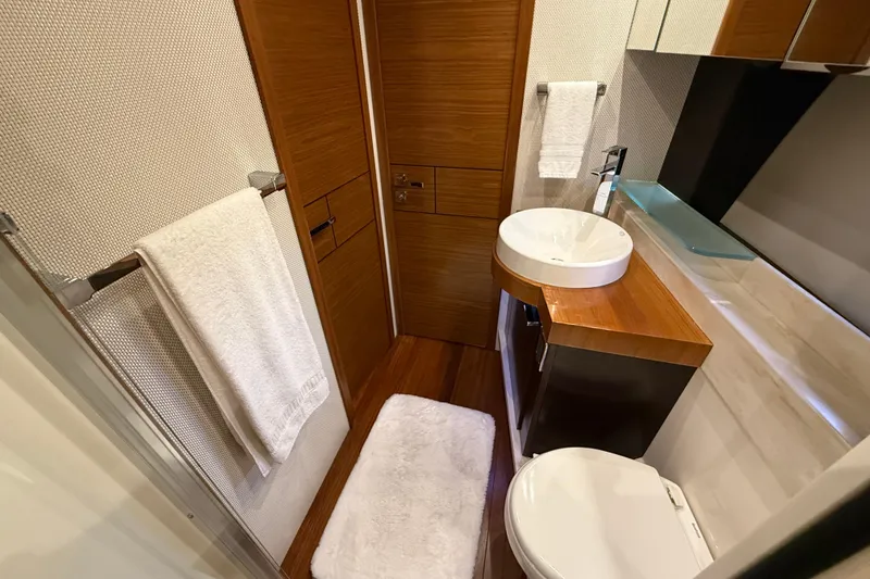 Slide: The Image of Luxurious bathroom in 2016 Tiara Yachts 50 Coupe, featuring modern fixtures and elegant wood finishes. - 39