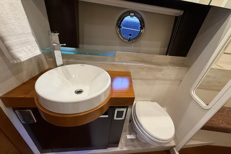 Slide: The Image of Luxurious bathroom in 2016 Tiara Yachts 50 Coupe with modern sink and porthole window. - 40