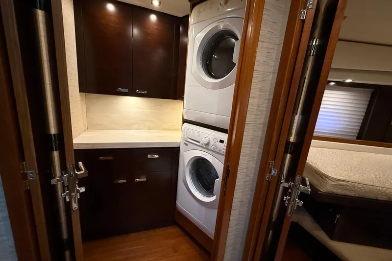 Slide: The Image of Laundry area in 2016 Tiara Yachts 50 Coupe with stacked washer and dryer. - 43