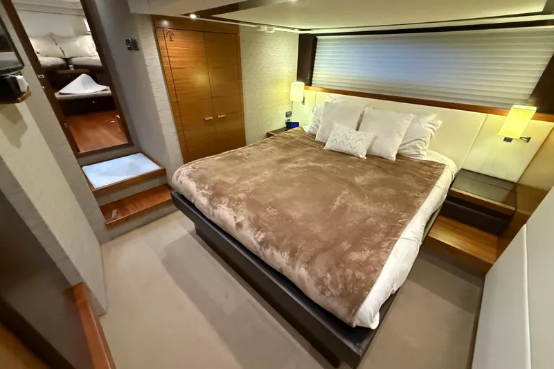Slide: The Image of Luxurious bedroom interior of 2016 Tiara Yachts 50 Coupe with cozy bedding and ambient lighting. - 45