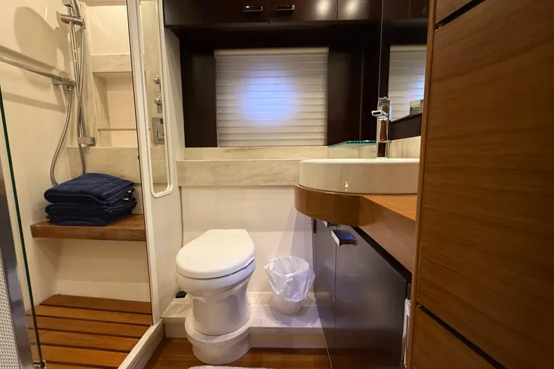 Slide: The Image of Bathroom interior of 2016 Tiara Yachts 50 Coupe, featuring modern fixtures and wooden accents. - 49
