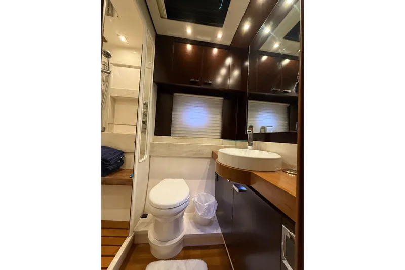 Slide: The Image of Luxurious bathroom in 2016 Tiara Yachts 50 Coupe with modern fixtures and elegant design. - 51