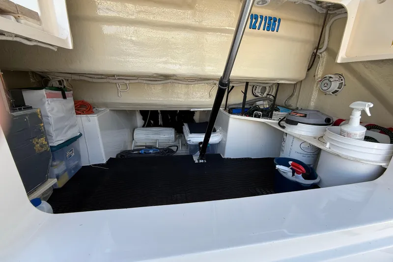 Slide: The Image of Storage area of a 2016 Tiara Yachts 50 Coupe with various equipment and supplies. - 55