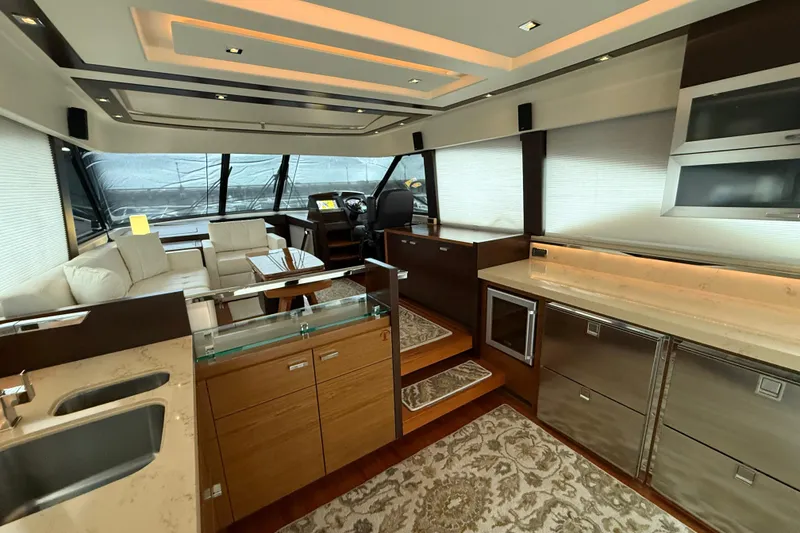 Slide: The Image of Luxurious interior of 2016 Tiara Yachts 50 Coupe with modern kitchen and seating area. - 8