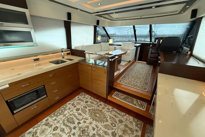 Slide: The Image of Luxurious interior of 2016 Tiara Yachts 50 Coupe with modern kitchen and seating area. - 9