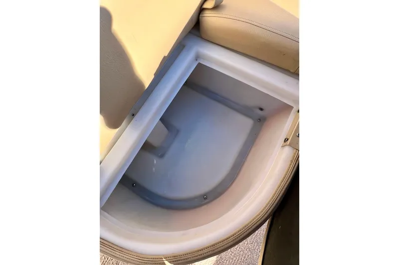 Slide: The Image of 2013 South Bay 417 CR boat storage compartment with beige interior. - 13
