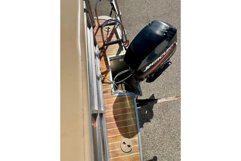 Slide: The Image of Storage compartment of a 2013 South Bay 417 CR boat with battery inside. - 31
