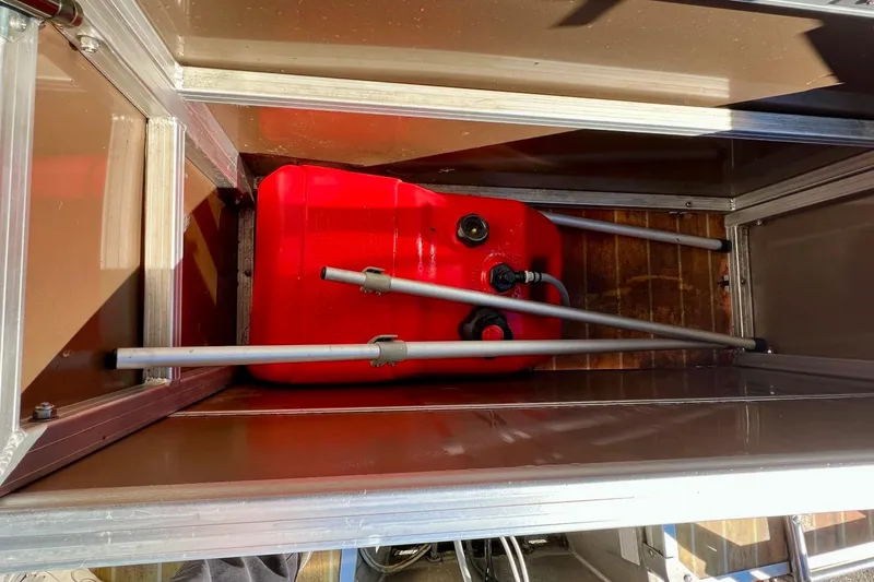 Slide: The Image of 2013 South Bay 417 CR boat interior with open storage compartments and steering console. - 33