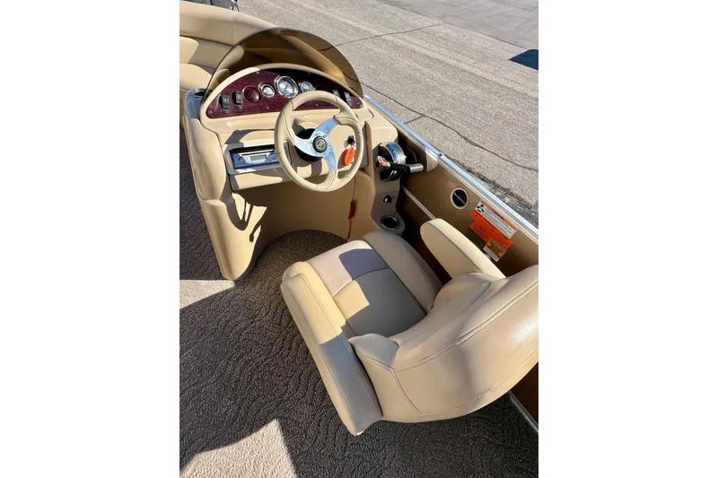 Slide: The Image of 2013 South Bay 417 CR boat interior with beige seating and steering console. - 36