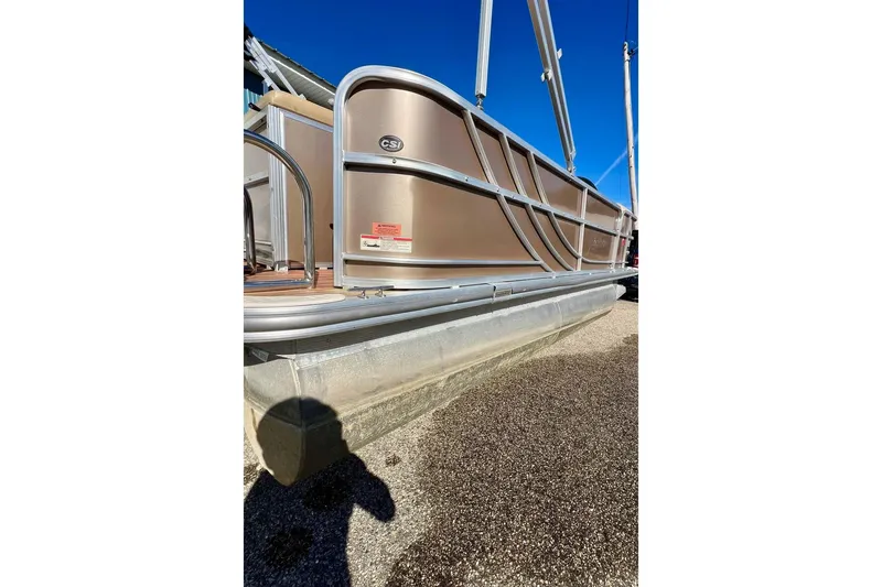 Slide: The Image of 2013 South Bay 417 CR pontoon boat parked outside a blue building. - 54