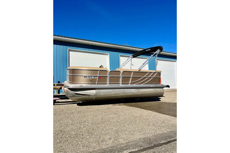 Slide: The Image of 2013 South Bay 417 CR pontoon boat parked outside a blue garage. - 55
