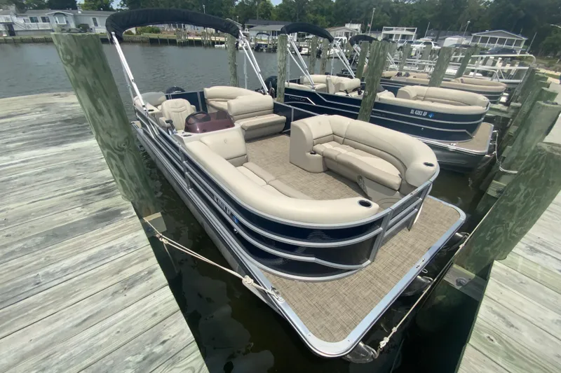 Slide: The Image of 2023 Cypress Cay Seabreeze 232 pontoon boat docked at a marina. - 2