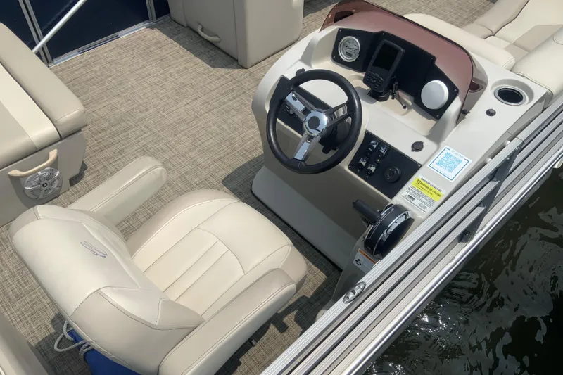 Slide: The Image of 2023 Cypress Cay Seabreeze 232 boat interior with steering console and seating. - 5