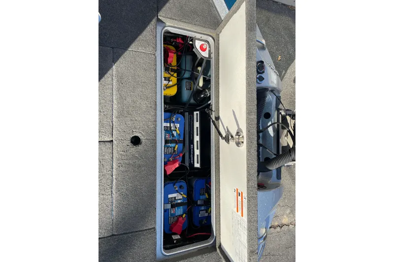 Slide: The Image of 2014 Ranger Z520C Carbon Comanche boat battery compartment with multiple batteries and wiring. - 21