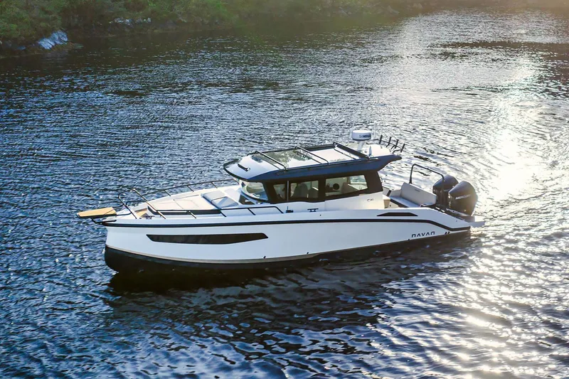 Slide: The Image of Manufacturer Provided Image: 2026 Navan C30 boat cruising on a serene waterway at sunset. - 2