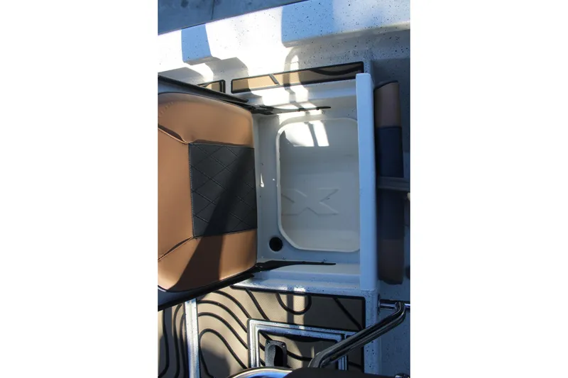 Slide: The Image of 2026 Xpress H20B Bay boat interior with brown and black seating. - 11